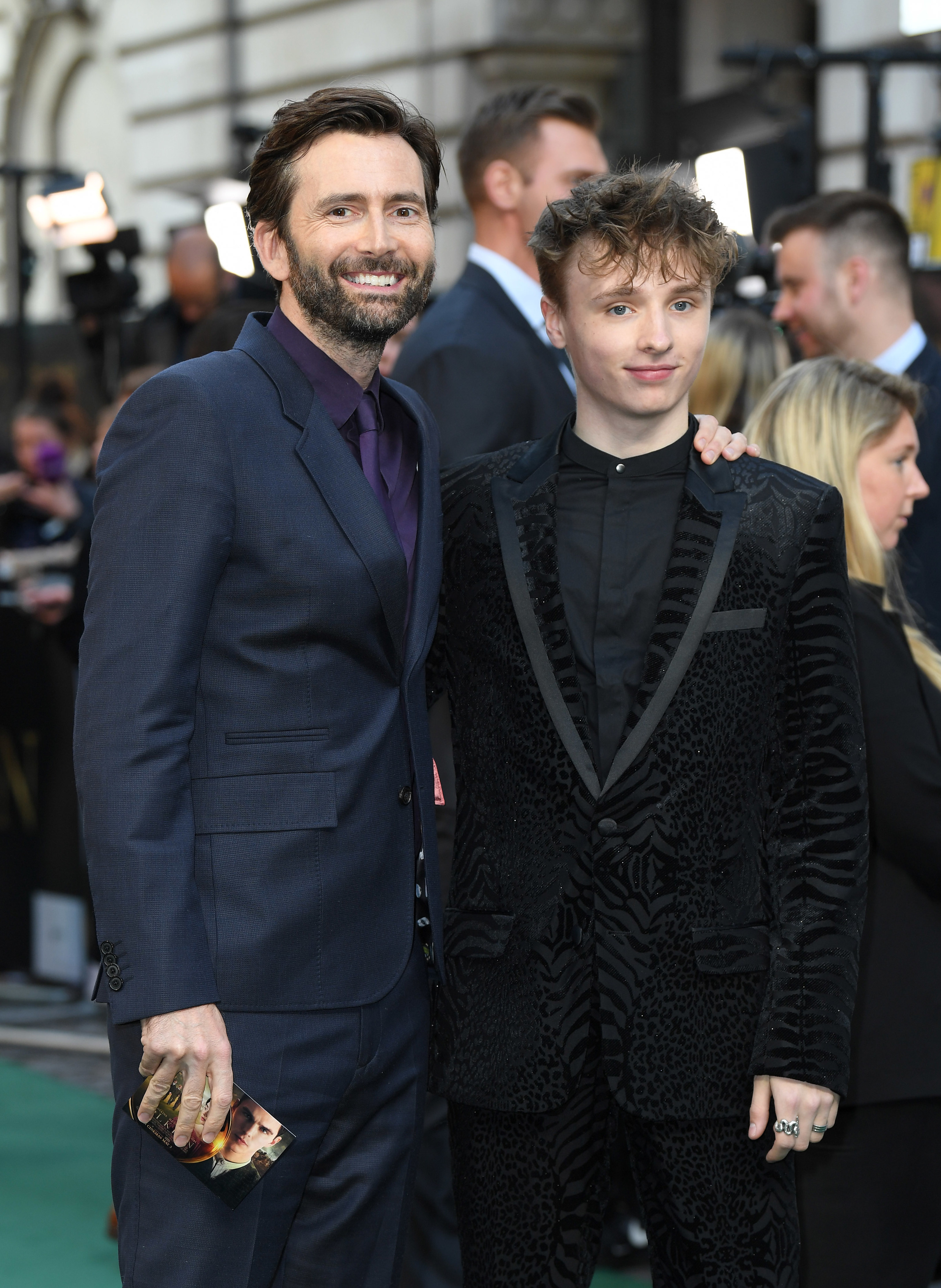 David and Ty on the red carpet smiling, with David&#x27;s arm on Ty&#x27;s shoulder