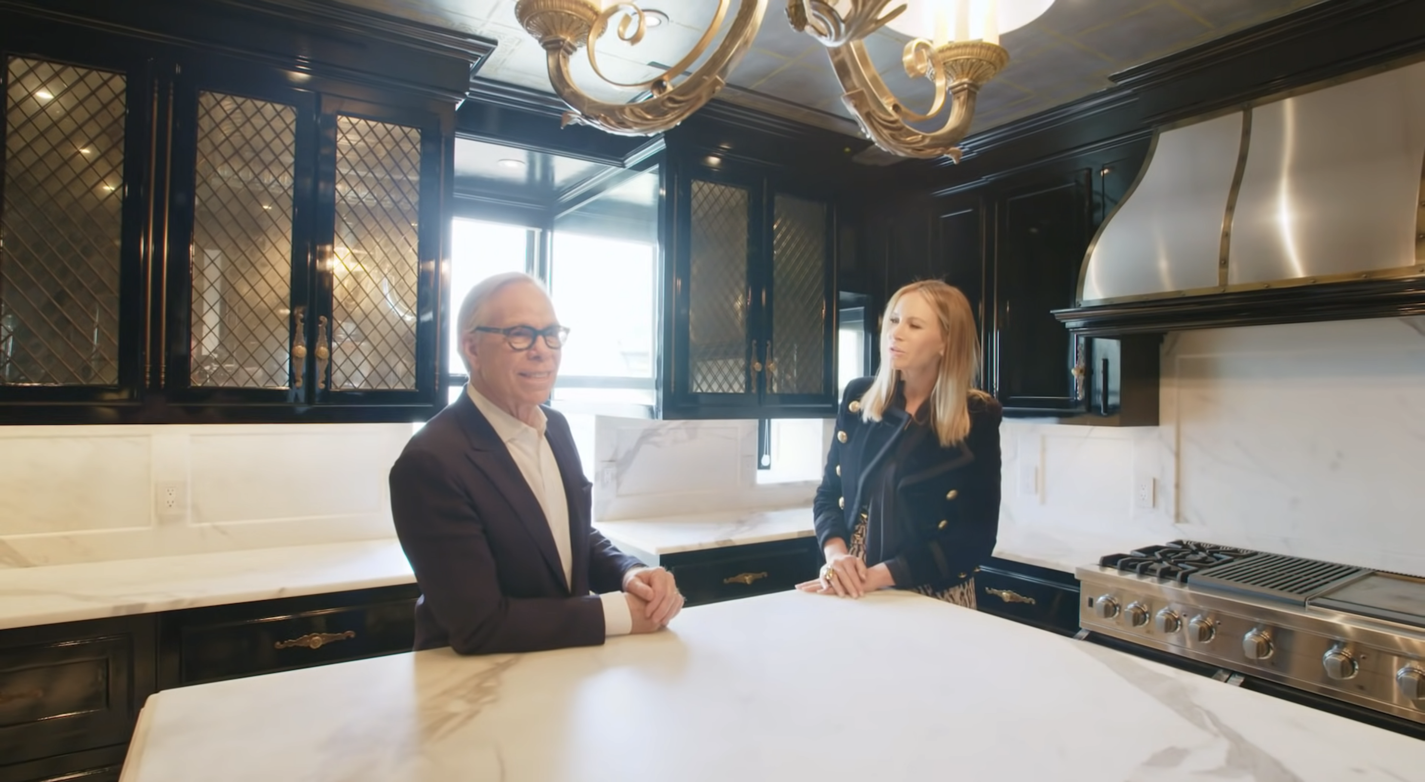 Tommy Hilfiger and his wife in their kitchen