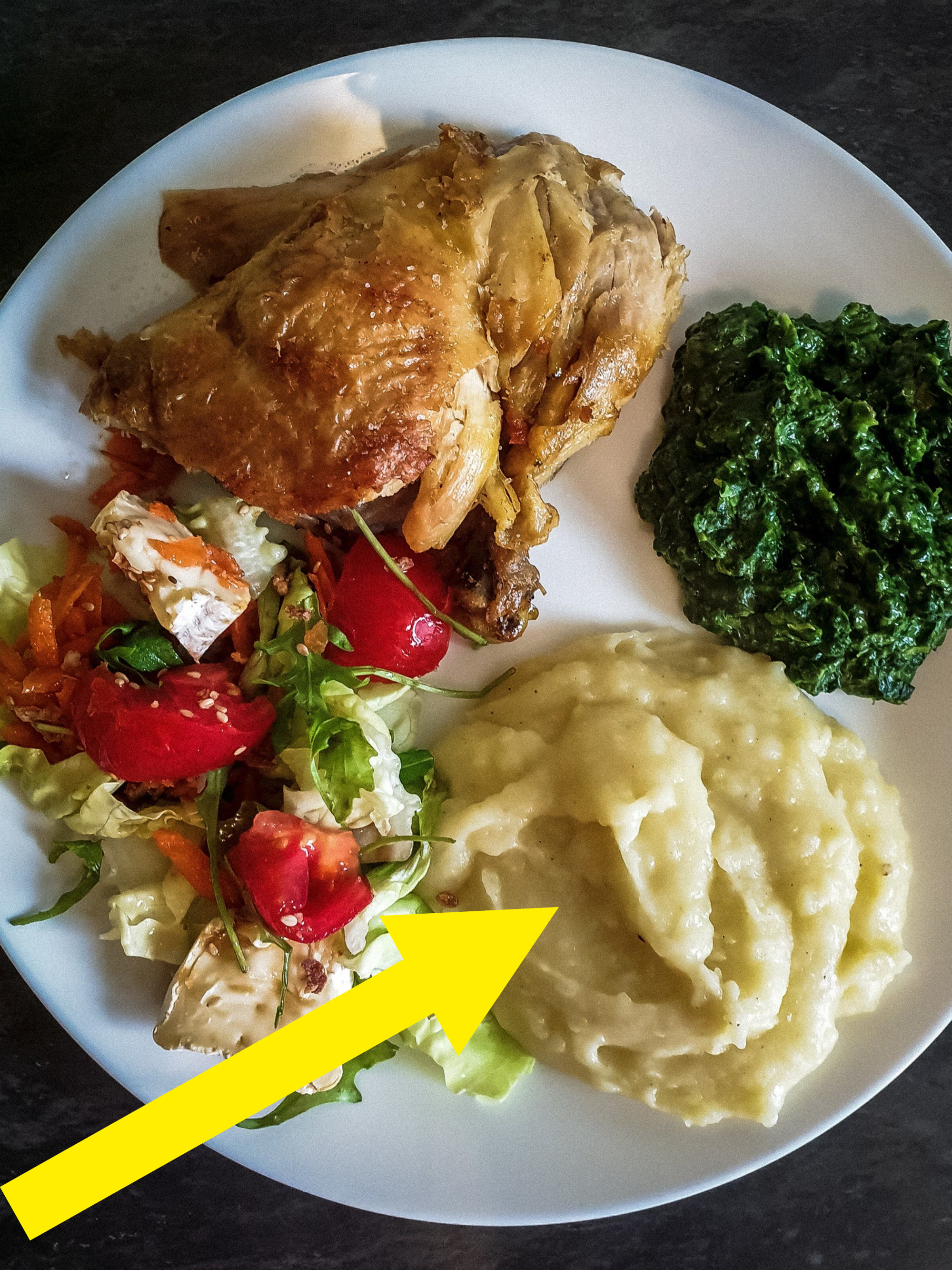 Roast chicken with salad, spinach, and mashed potatoes