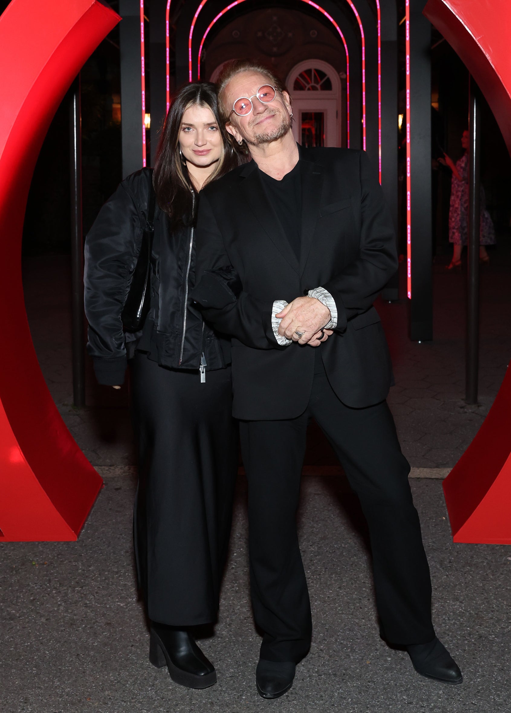 Eve and Bono standing together, both dressed in black