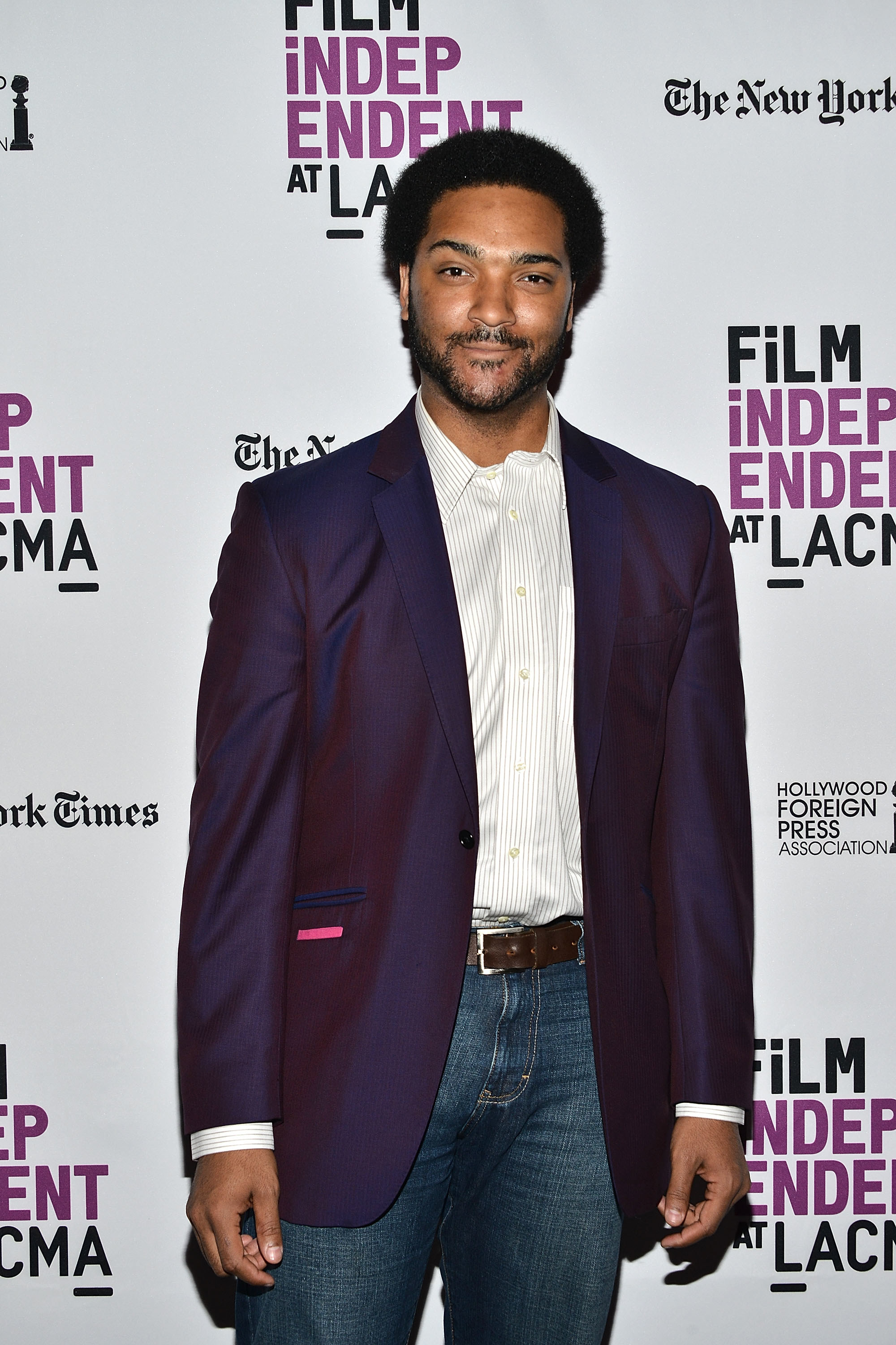 Langston in jeans, shirt, and jacket on the red carpet