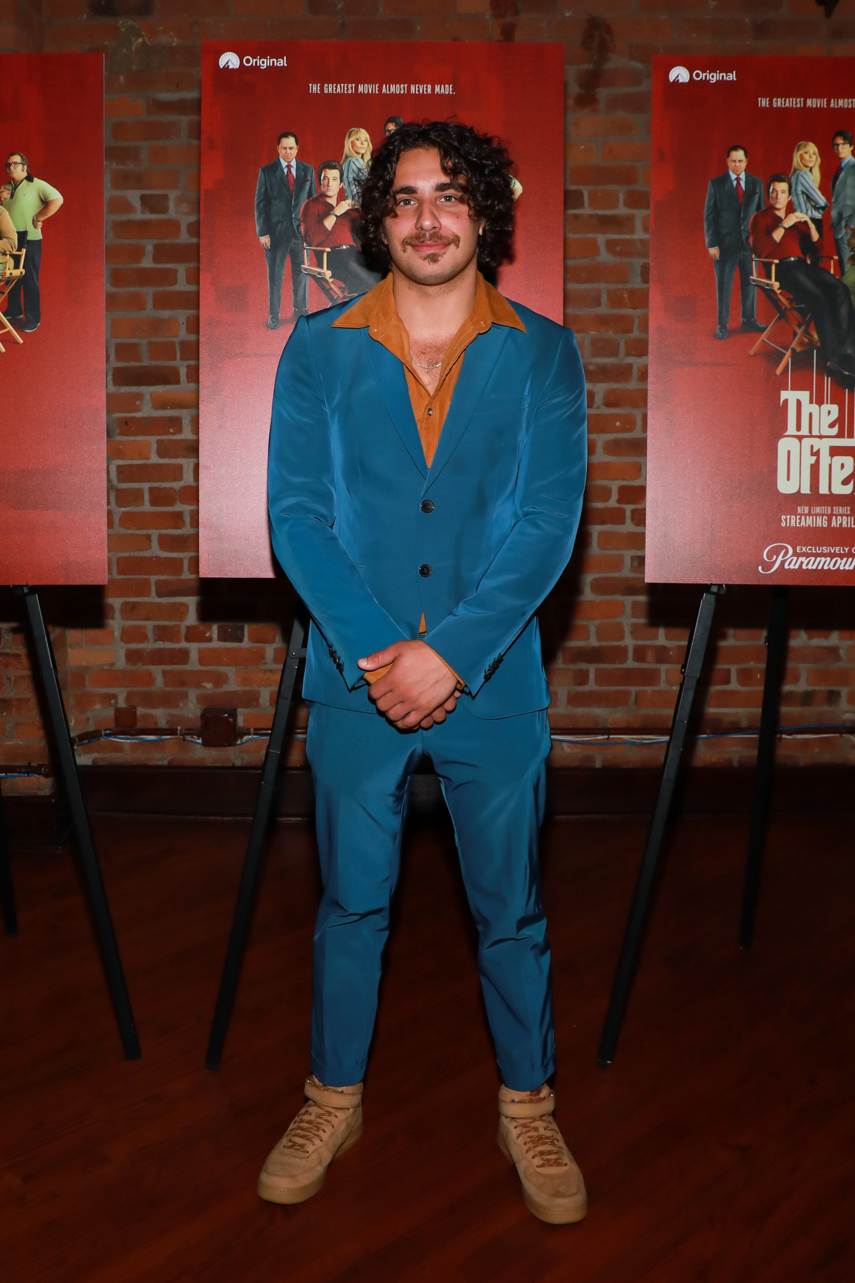 Jake smiling in a blue suit, no tie, on the red carpet