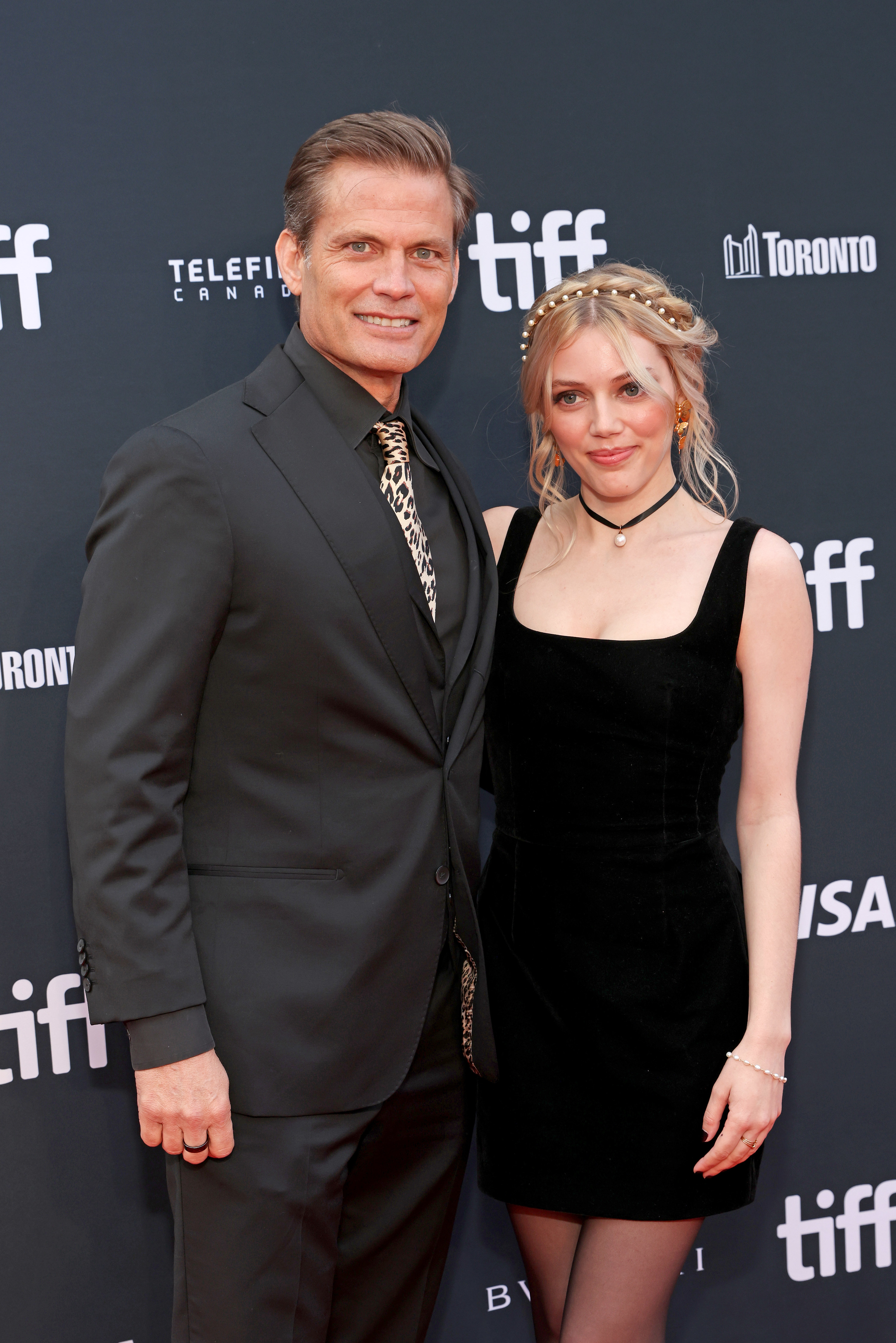Casper in a suit and Chrissy, in a minidress, on the red carpet