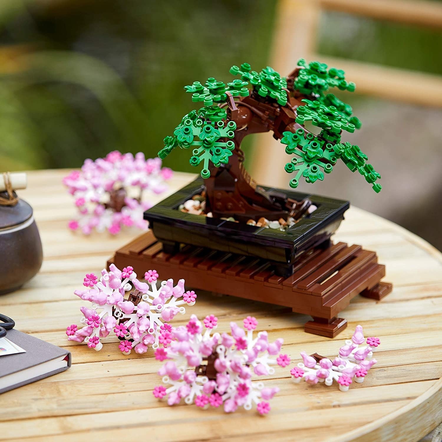 the lego bonsai tree with the cherry blossom leaves on a table