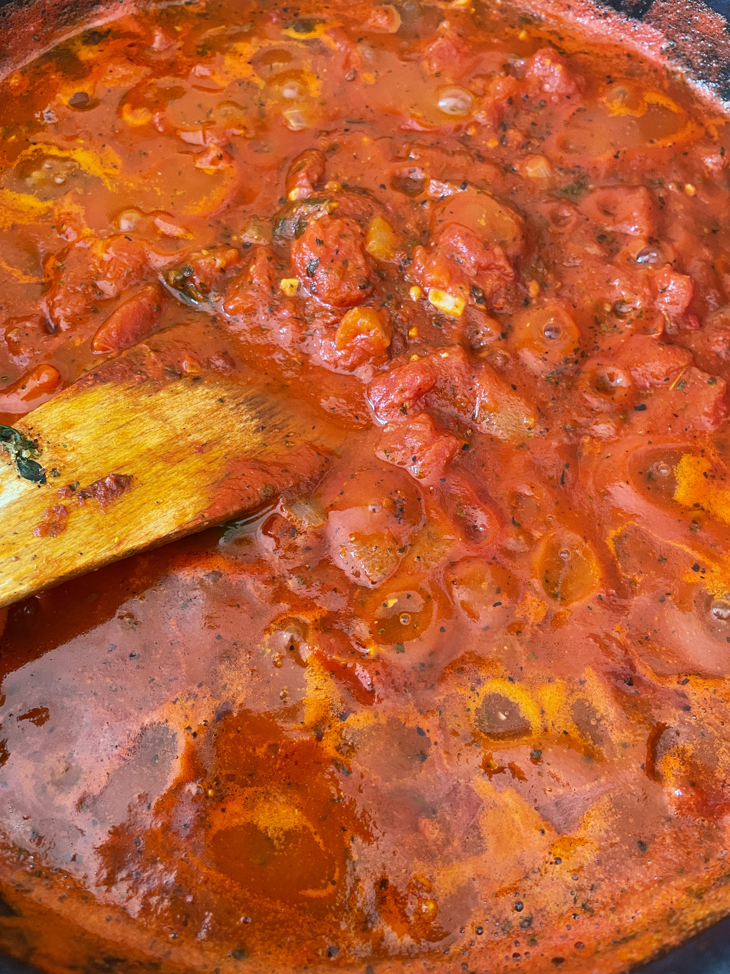 Stirring tomato sauce in a pan