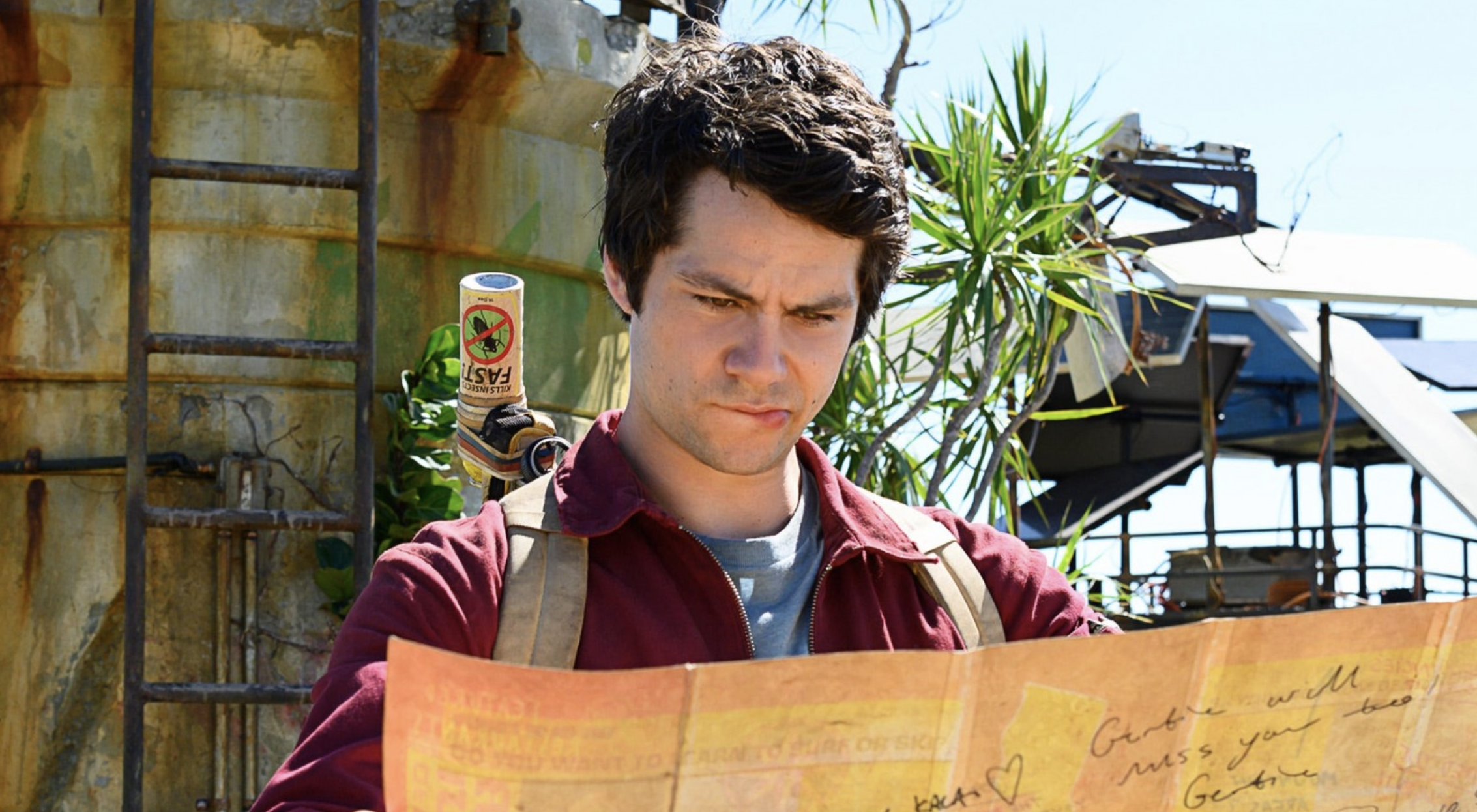 dylan obrien looks at a map and bites his lip