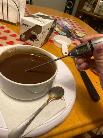 a reviewer using the thermometer in ganache