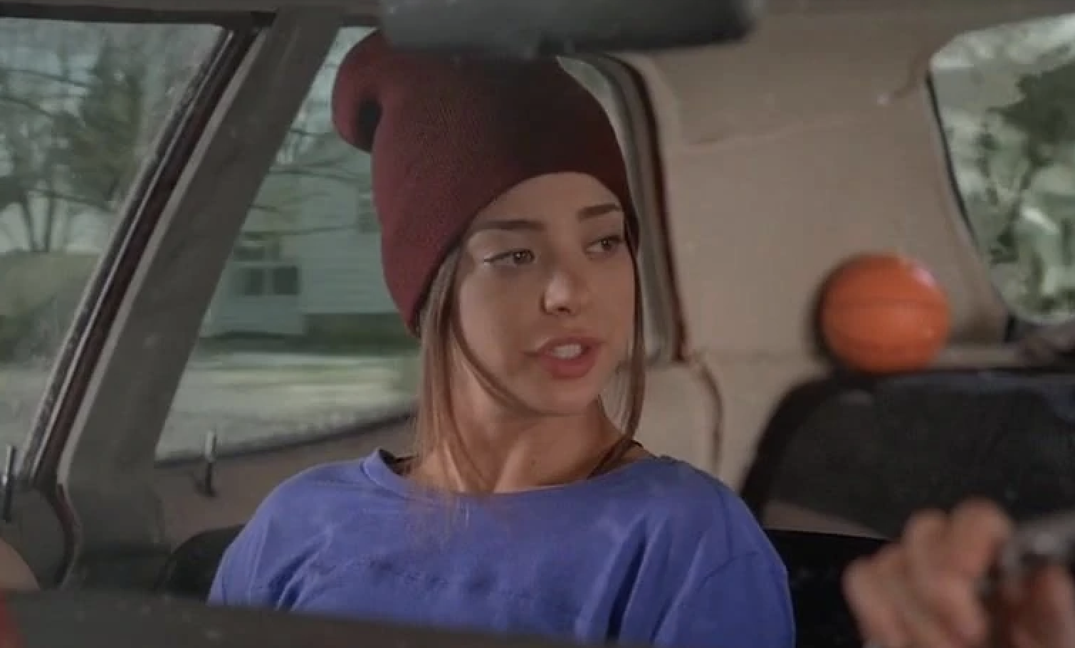 Gia in a car wearing a beanie