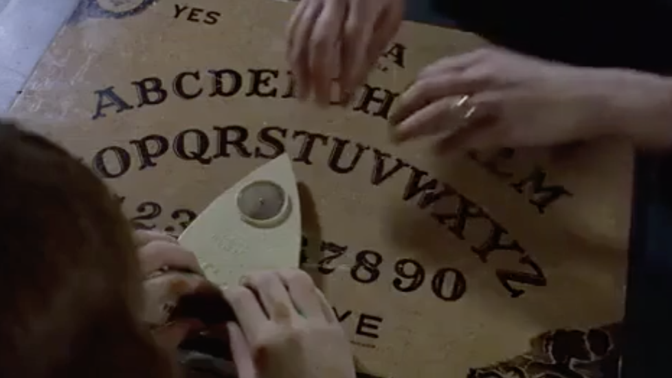 hands over a Ouija board