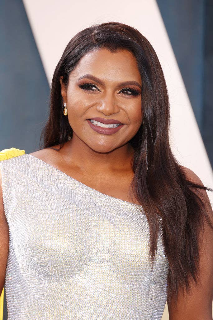 A closeup of a smiling Mindy who&#x27;s wearing a one-shoulder sequined gown