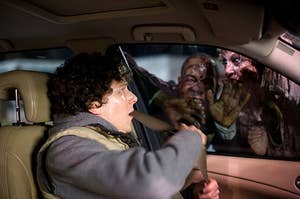 in the car being attacked by zombies