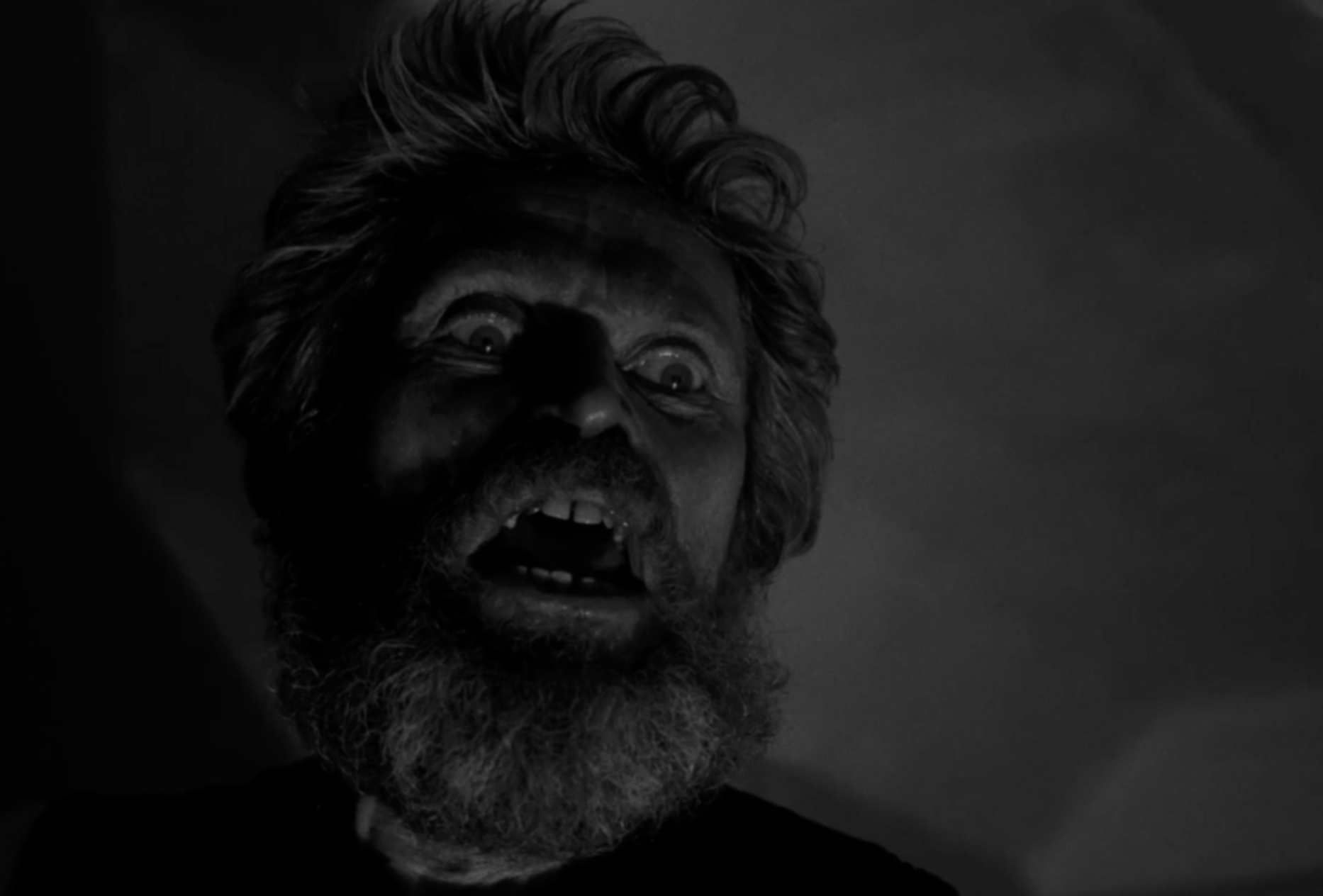 closeup of a scared man in the shadows