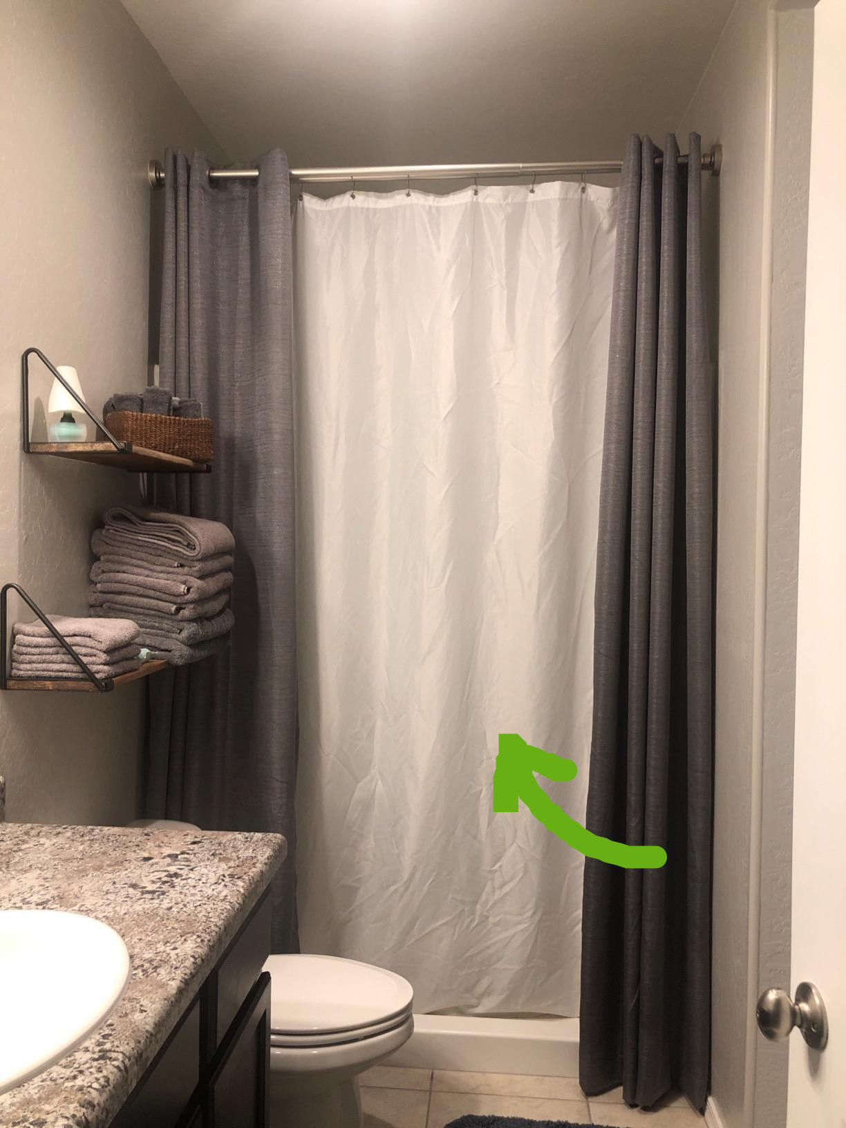 Reviewer image of white liner inside shower with two gray shower curtains in bathroom 