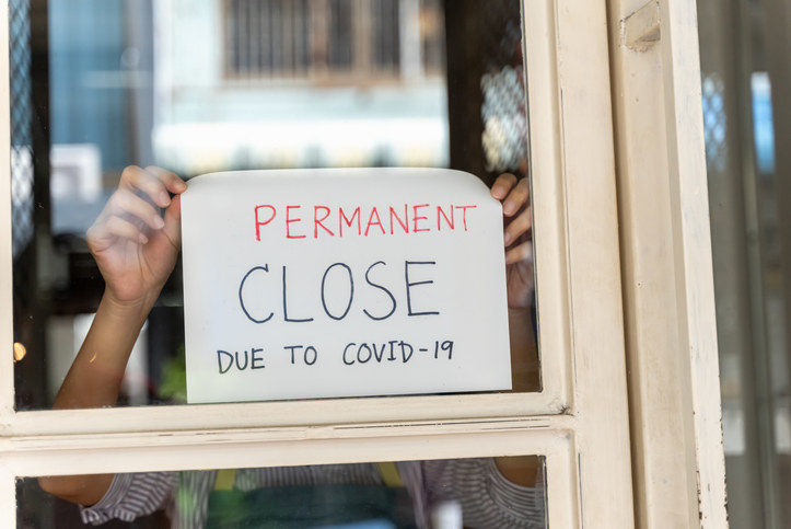 sign on window that says, Permanent close due to covid