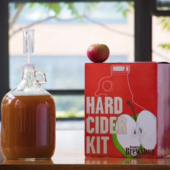 Jug of Hard Cider next to hard cider kit box.