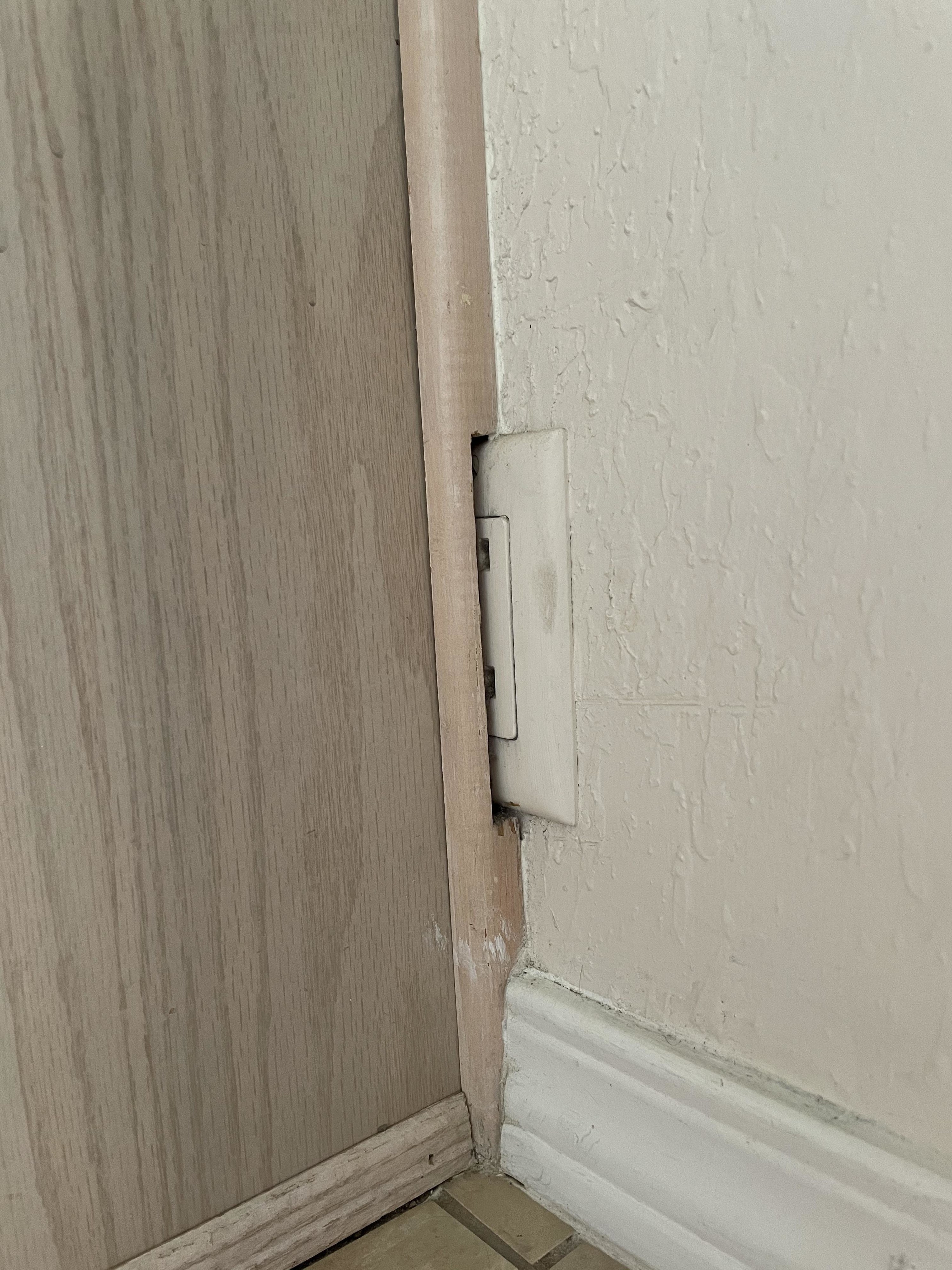 Outlet half hidden behind a wall