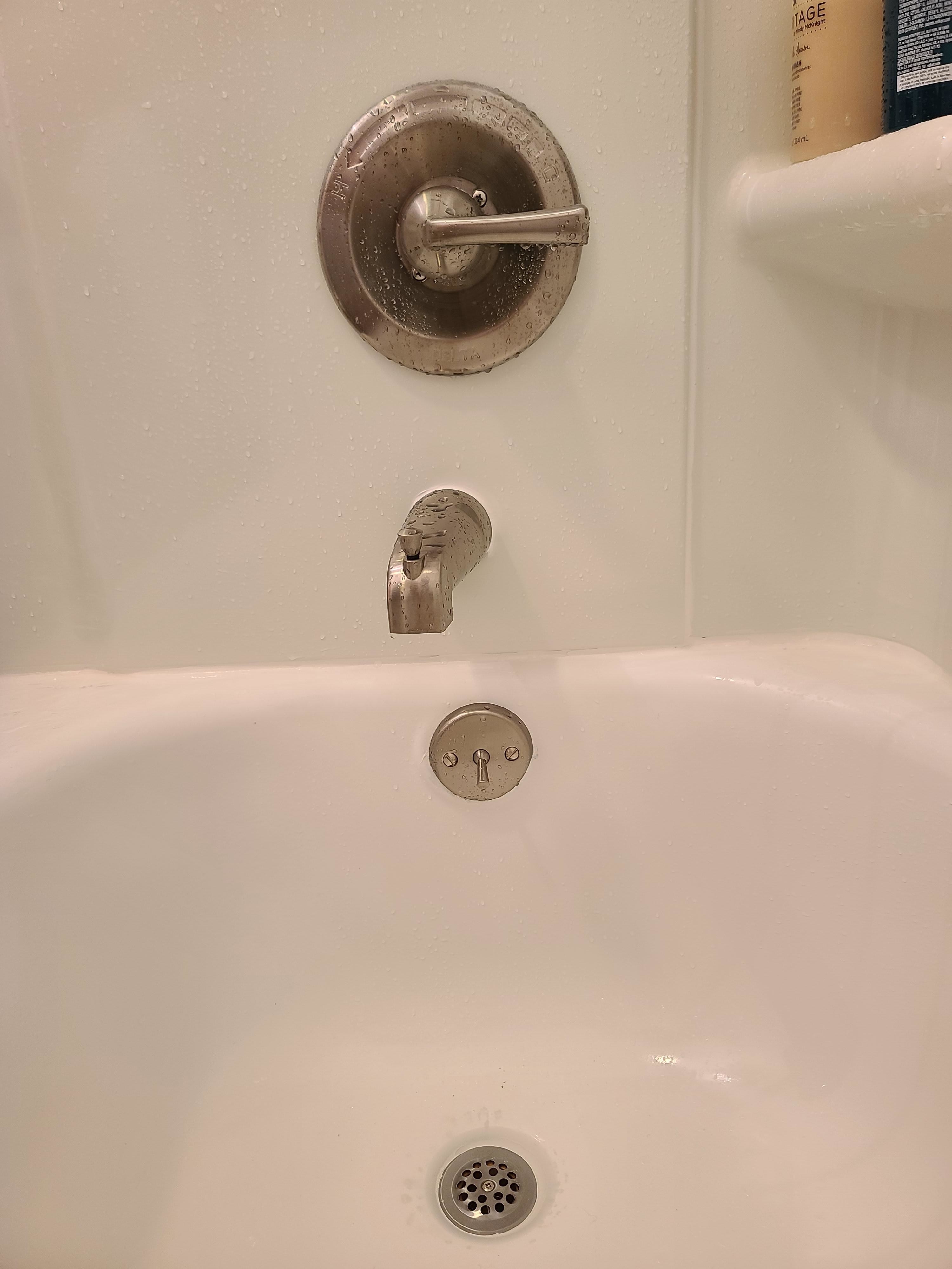 Misaligned faucet and handles in a bathtub