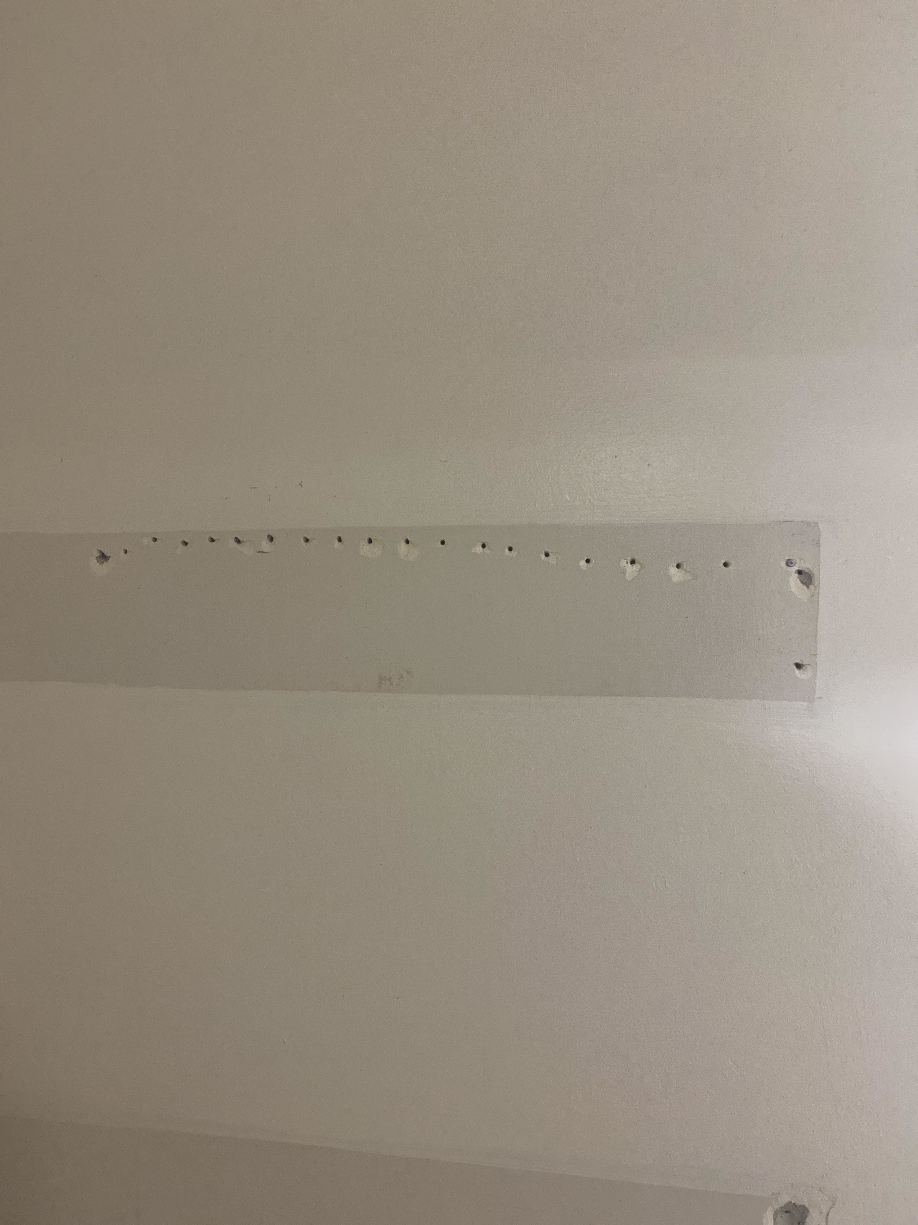 A row of small holes in a wall