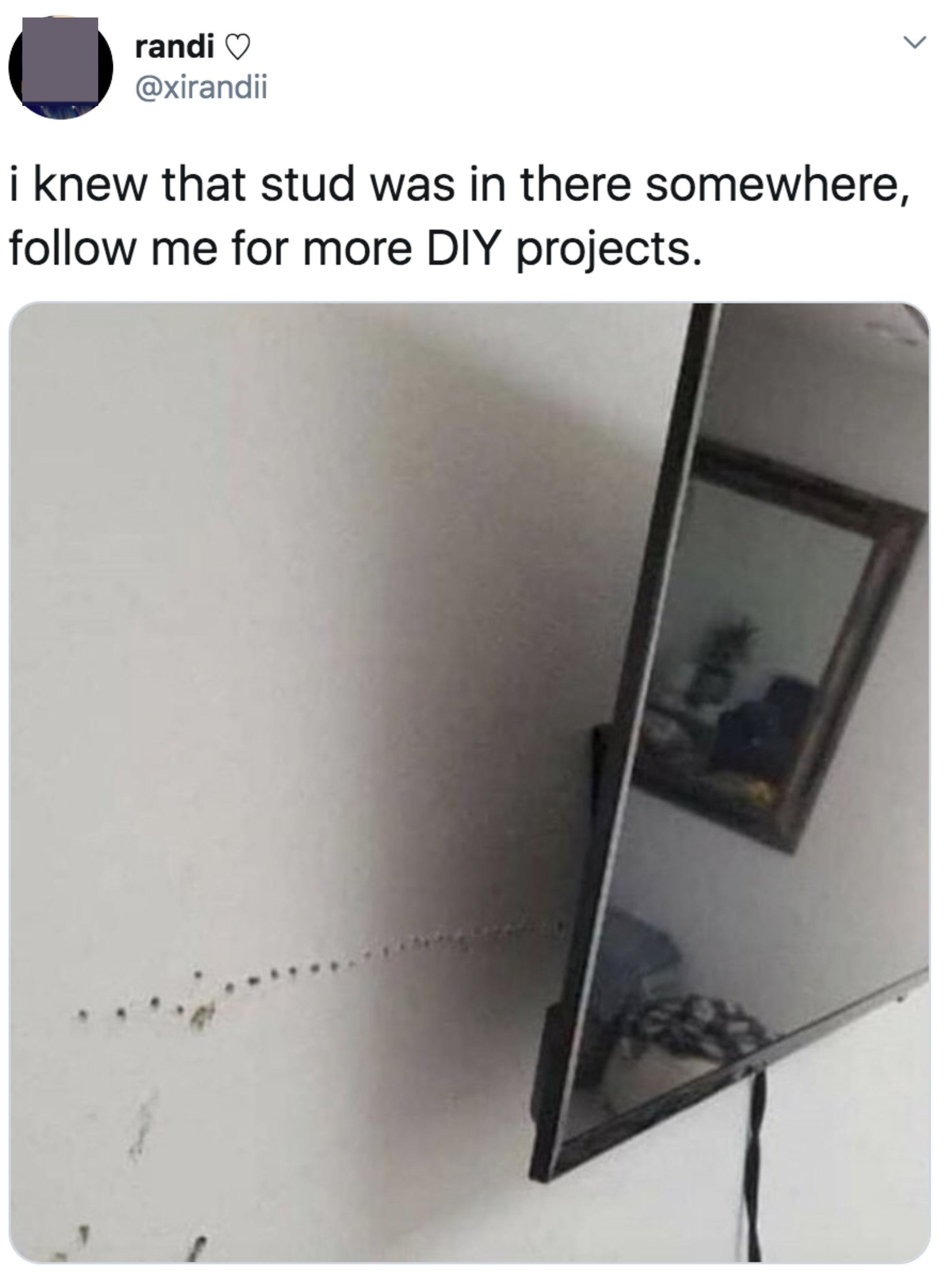 Many holes in a wall looking for a stud