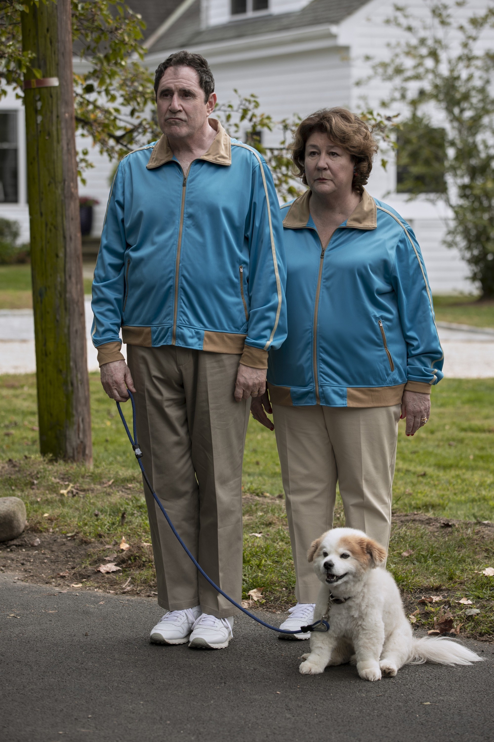 Kind and Martindale in matching jogging suits and walking their dog in &quot;The Watcher&quot;