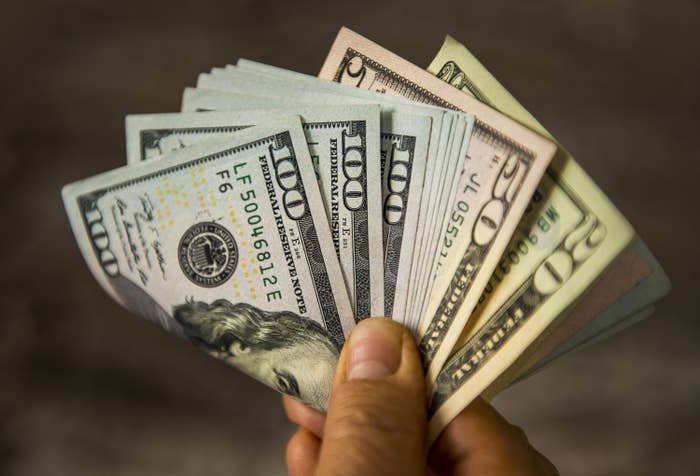 man holding US Dollar bills