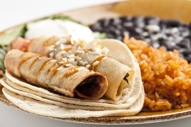 plate of flautas and rice and beans