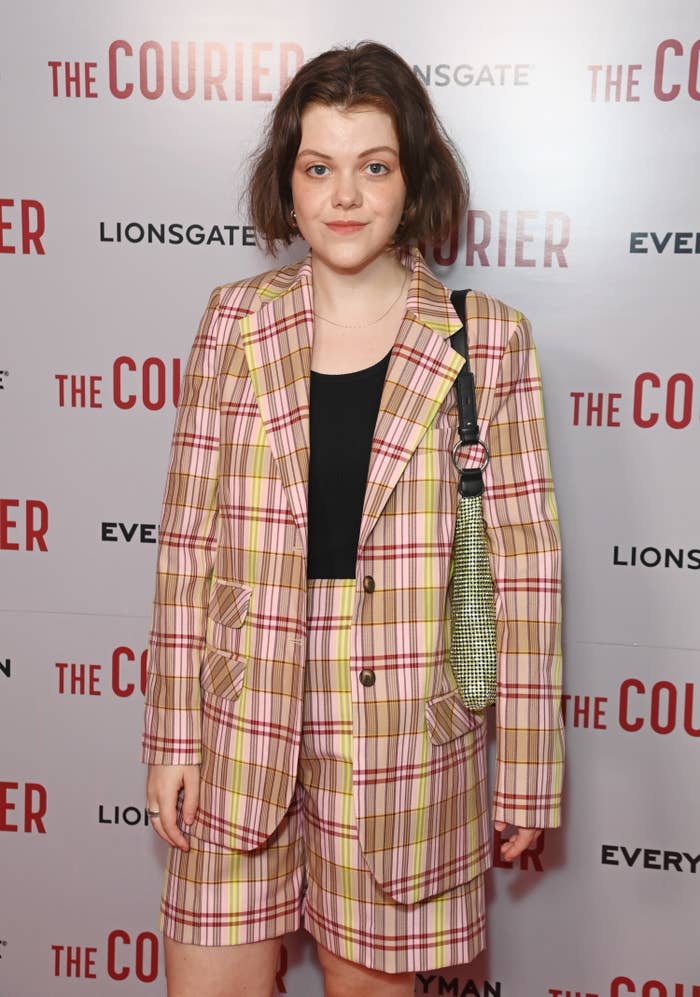 Georgie wearing a plaid shorts with a matching blazer and T-shirt at a red carpet event