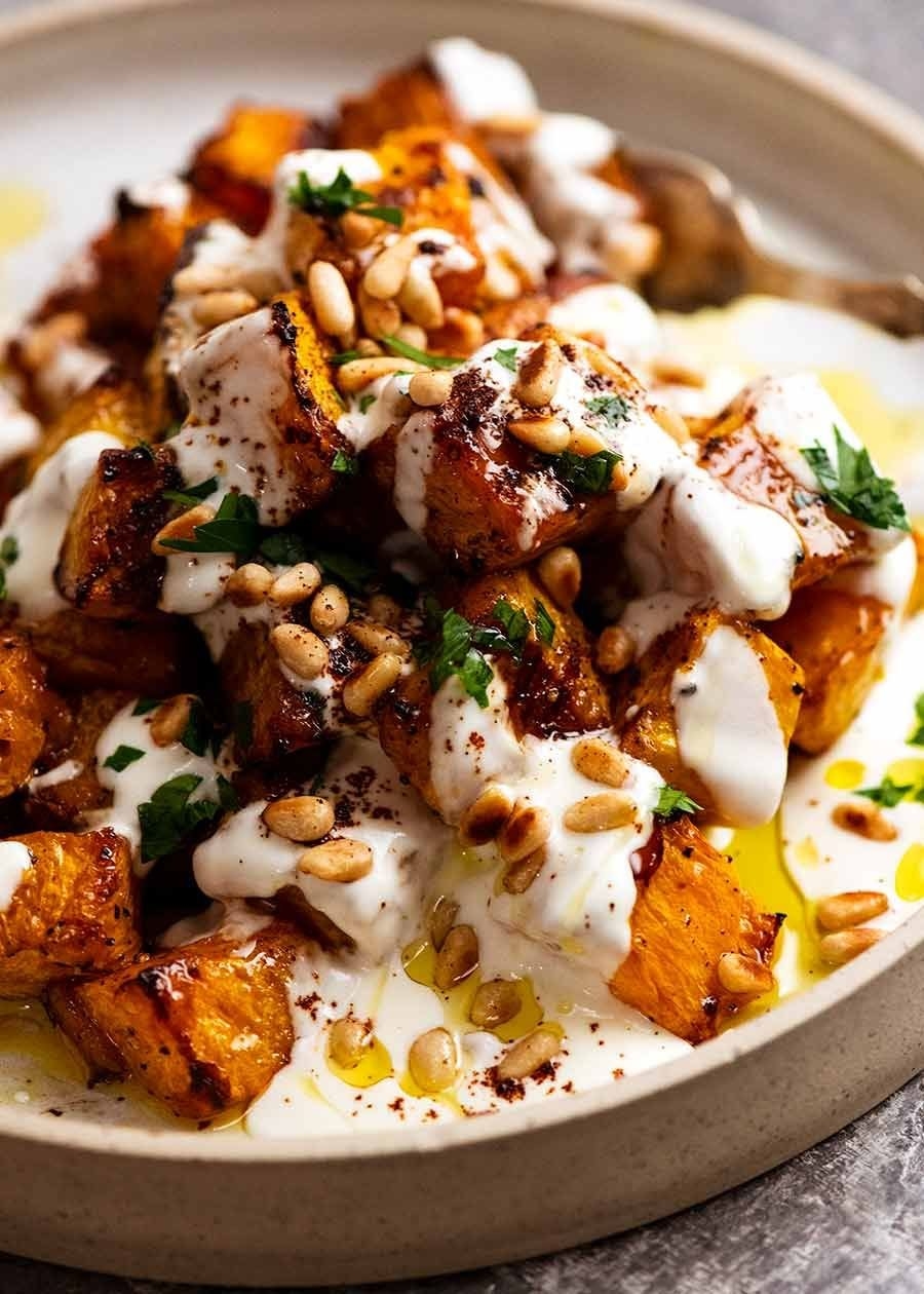 Roasted pumpkin topped with yogurt sauce and pine nuts
