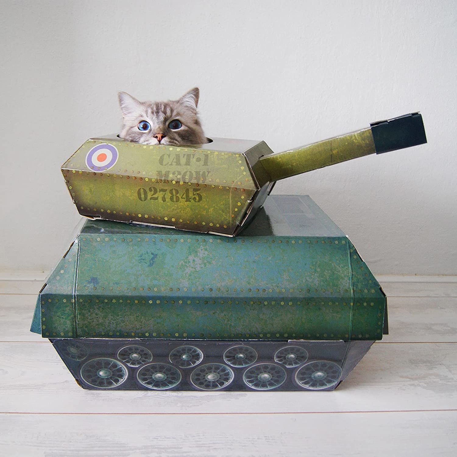 a cat peeking out of a cardboard tank