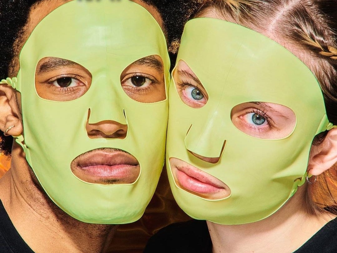 a pair of people wearing the reusable silicone sheet masks