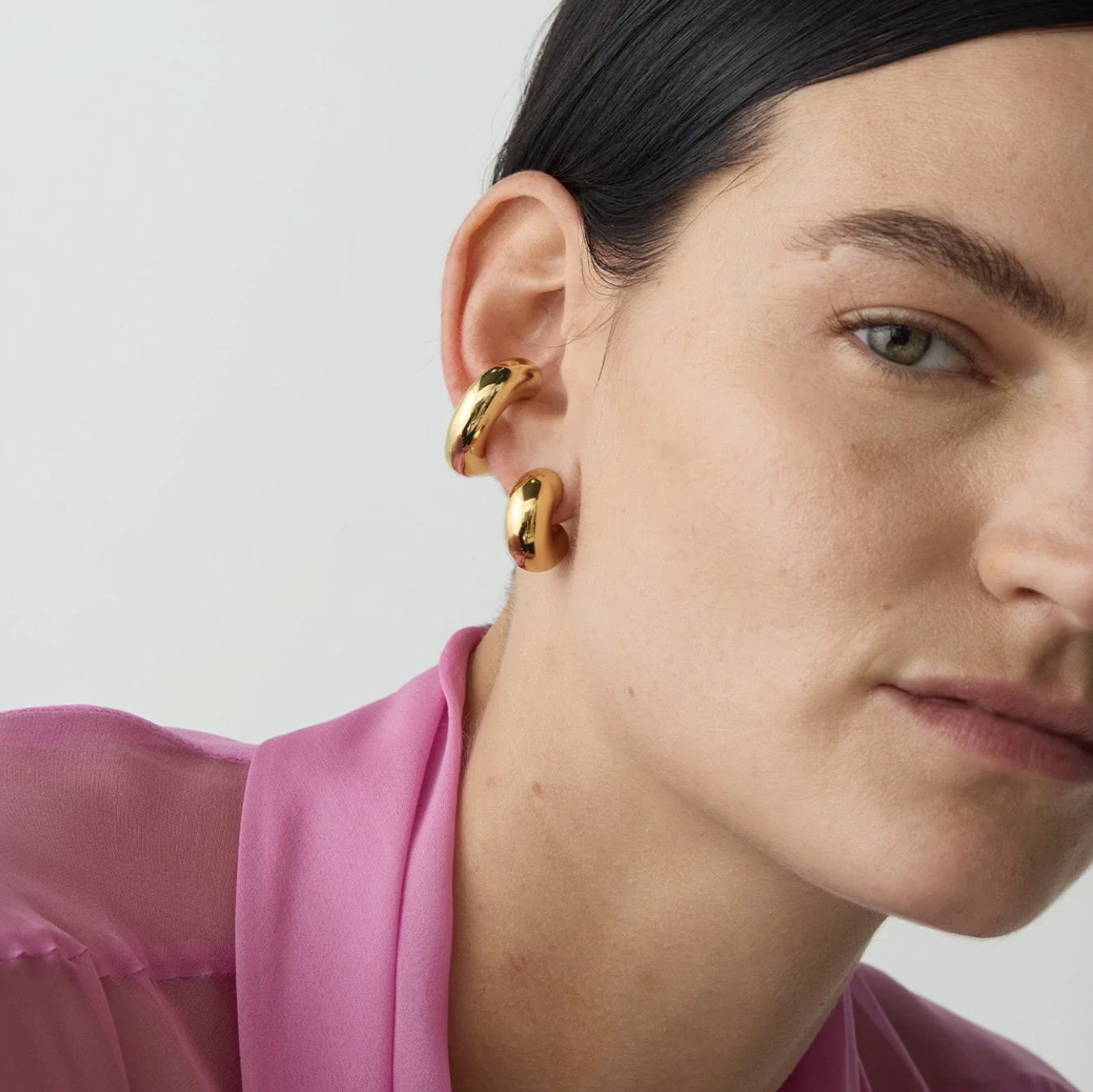 a close up of a person wearing the chunky cuff earring on their ear