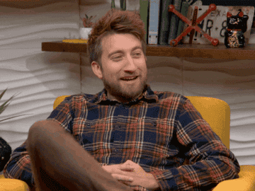 Gavin Free happily cozying up in his seat during an episode of Always Open