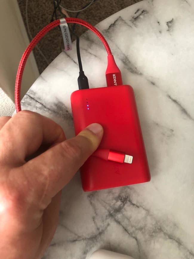the rectangle power bank in red with cords coming out to it