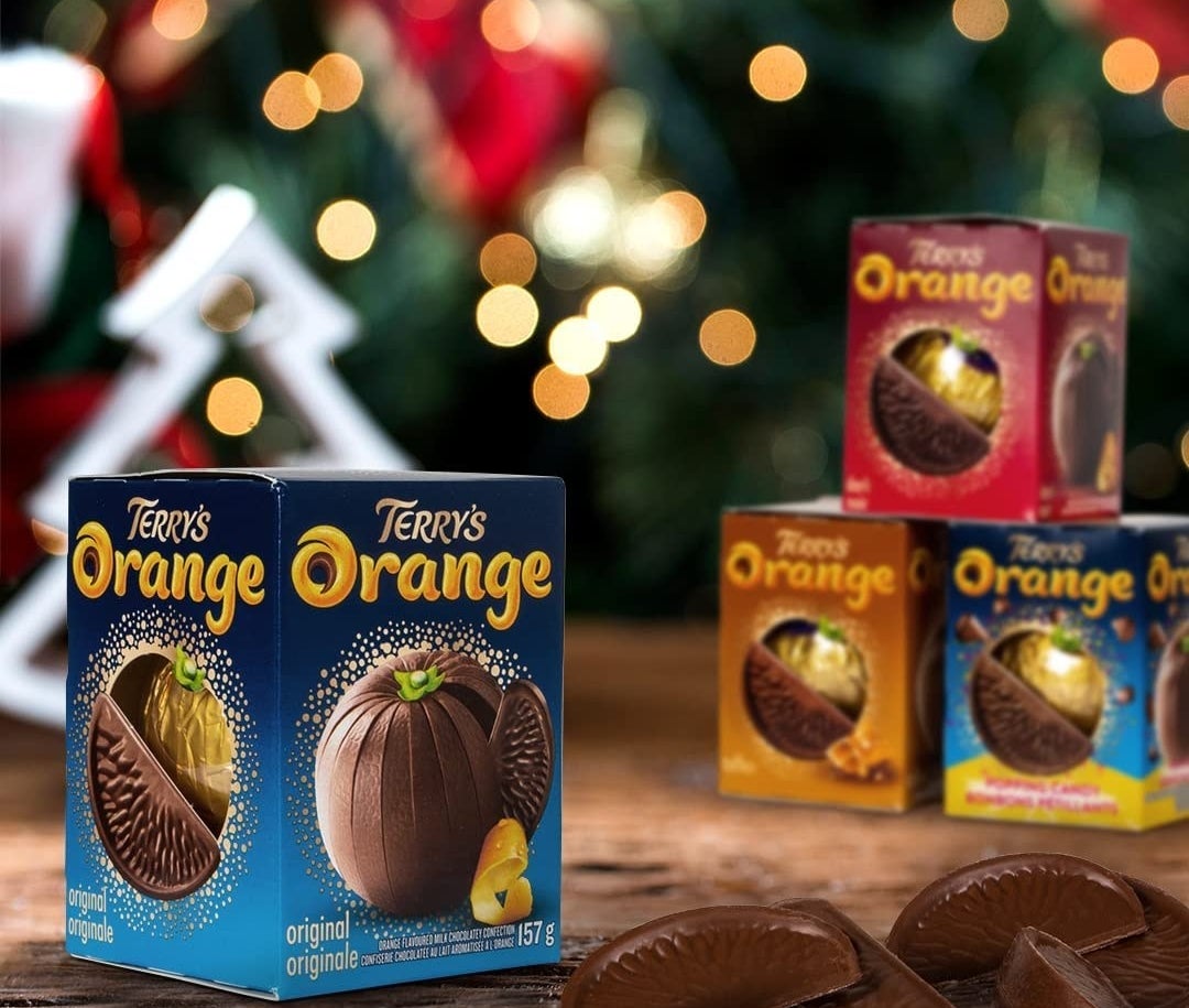 a terry&#x27;s chocolate orange with festive lights in the background