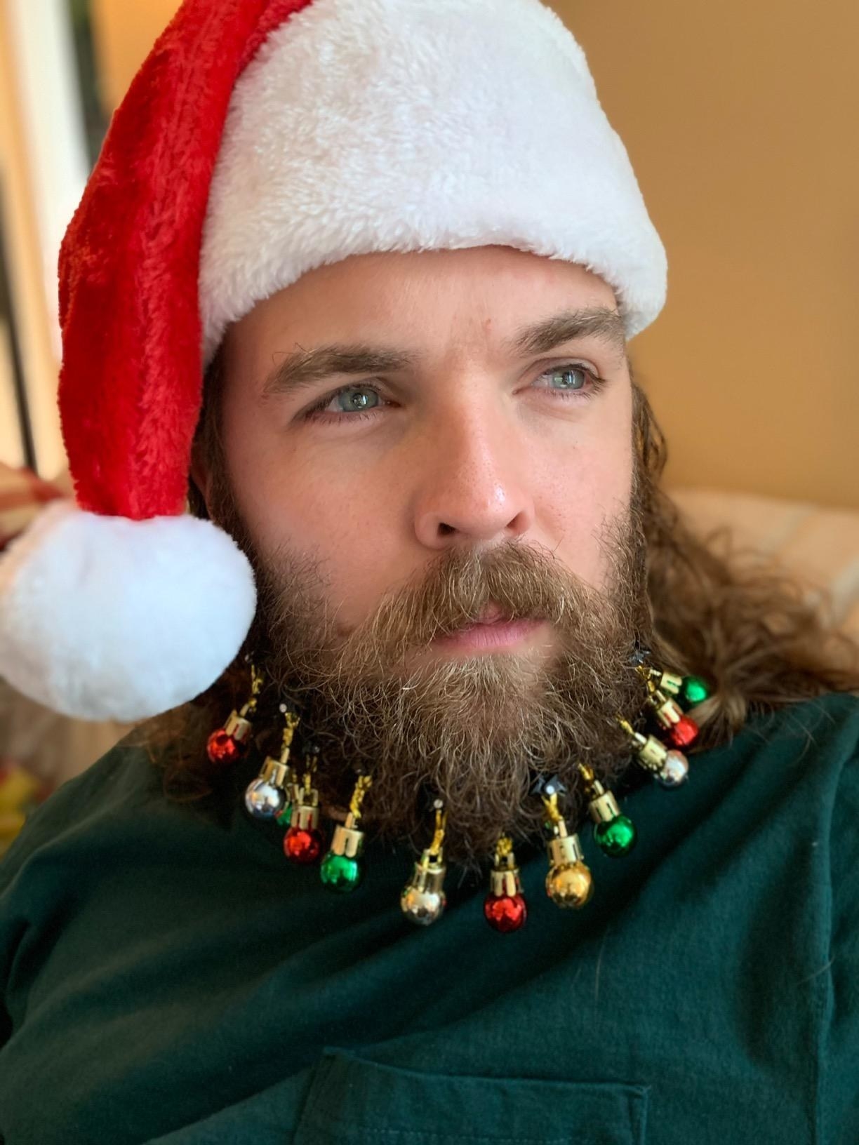 image of reviewer with baubles in their beard