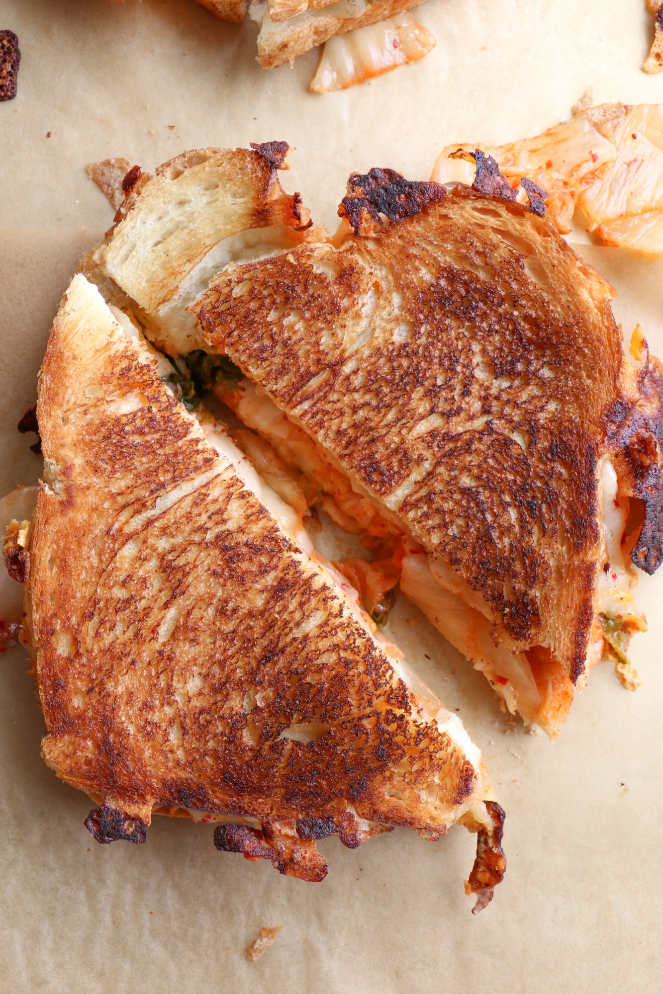 grilled bread sliced on a diagonal with kimchi inside