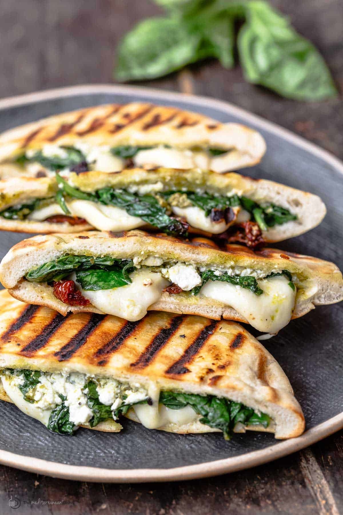 grilled pita bread with spinach, cheese and tomatoes inside