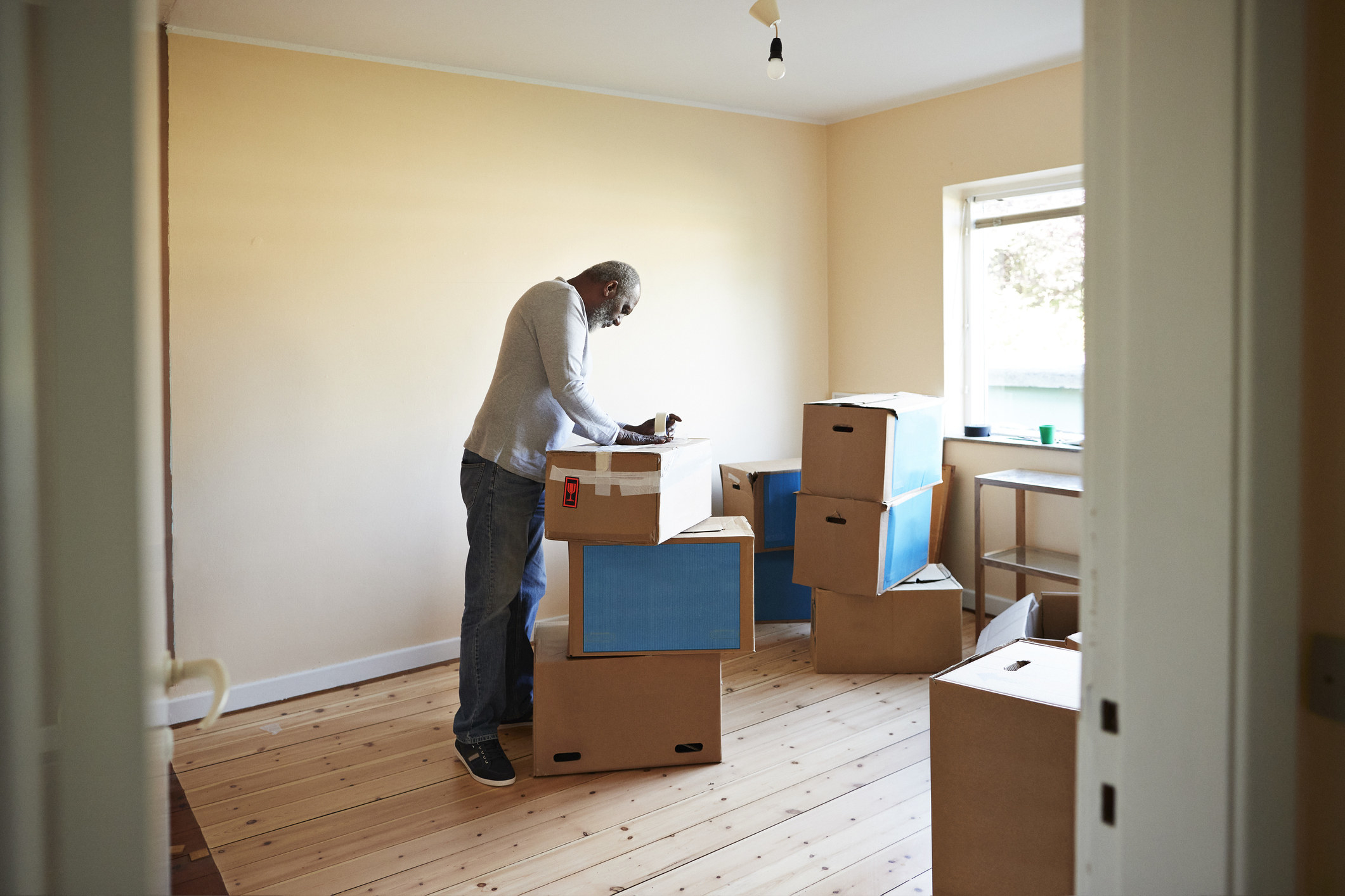 Man packing up moving boxes