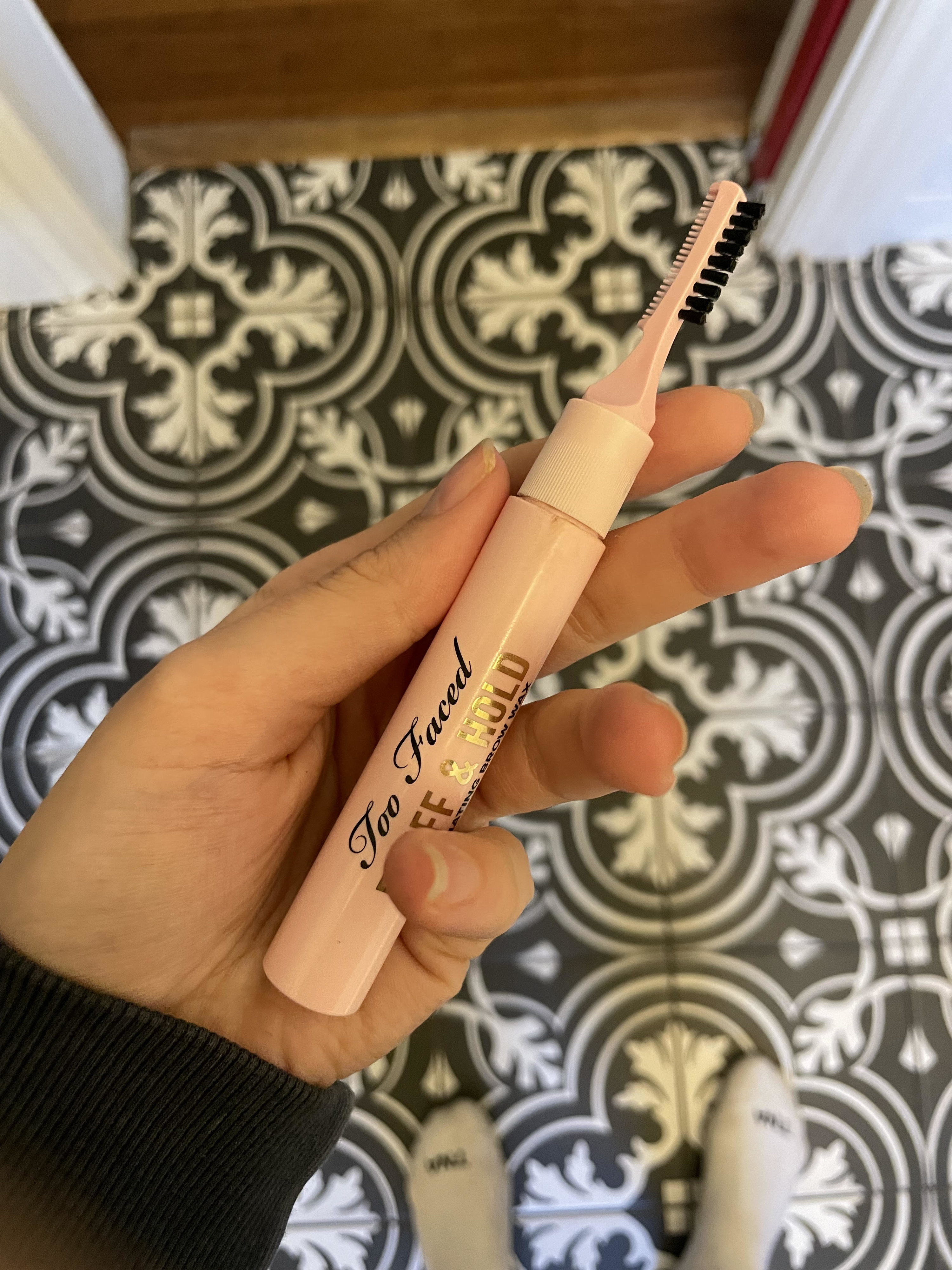 Alice holding the Too Faced brow gel