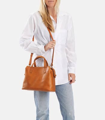 a model with a tan handbag