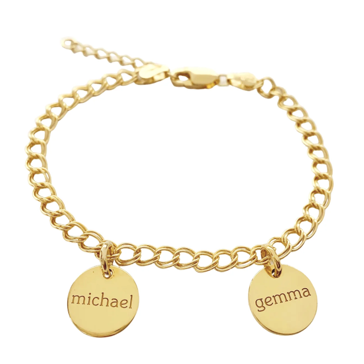 a gold bracelet with two circle charms on it with names engraved on each one