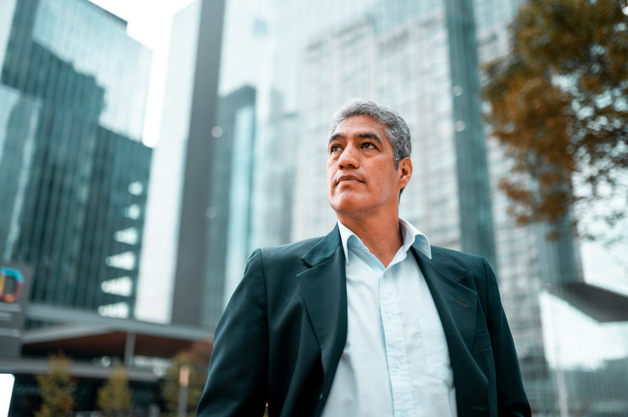 Older businessperson with buildings in back