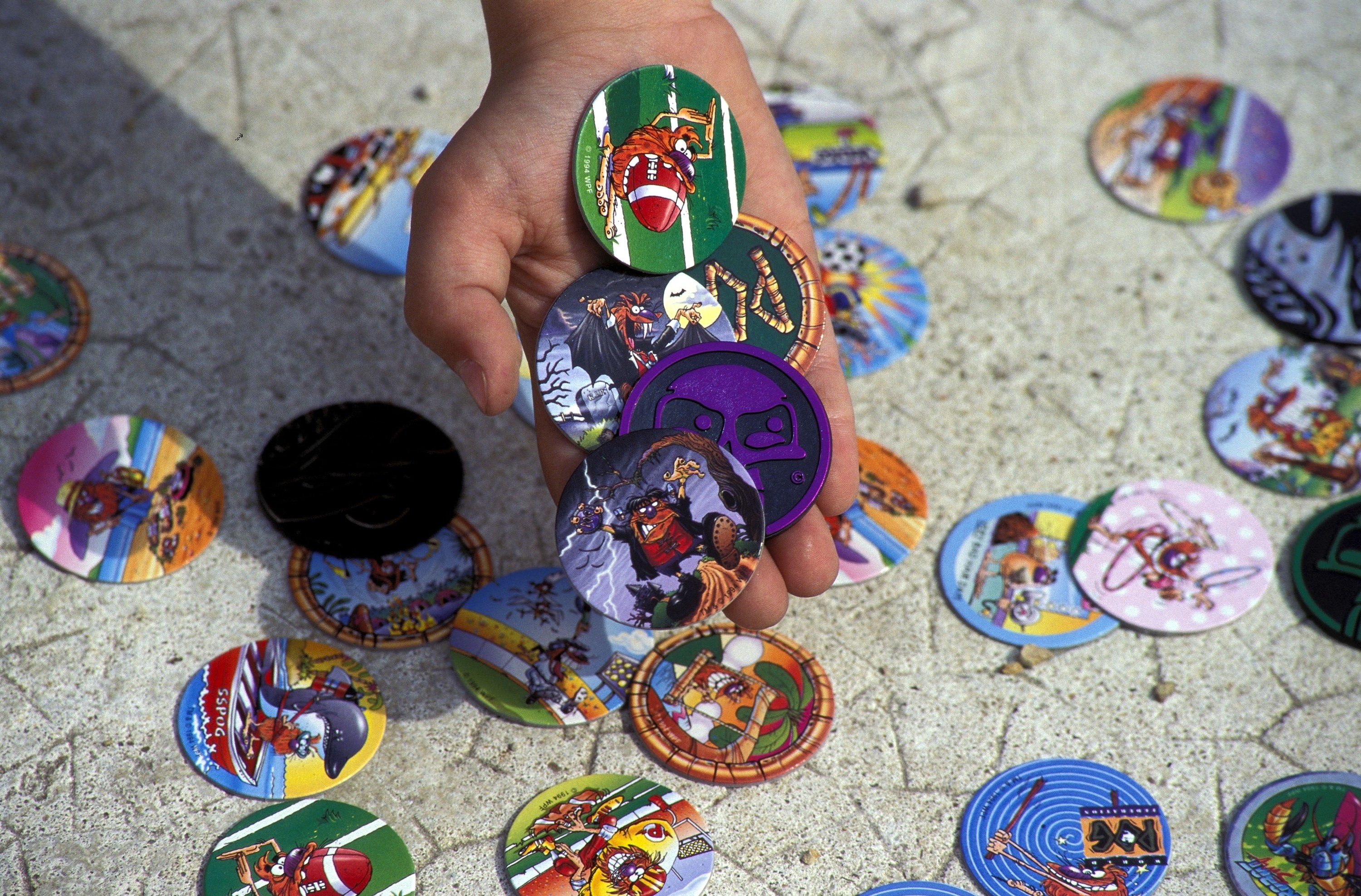 a kid holding pogs