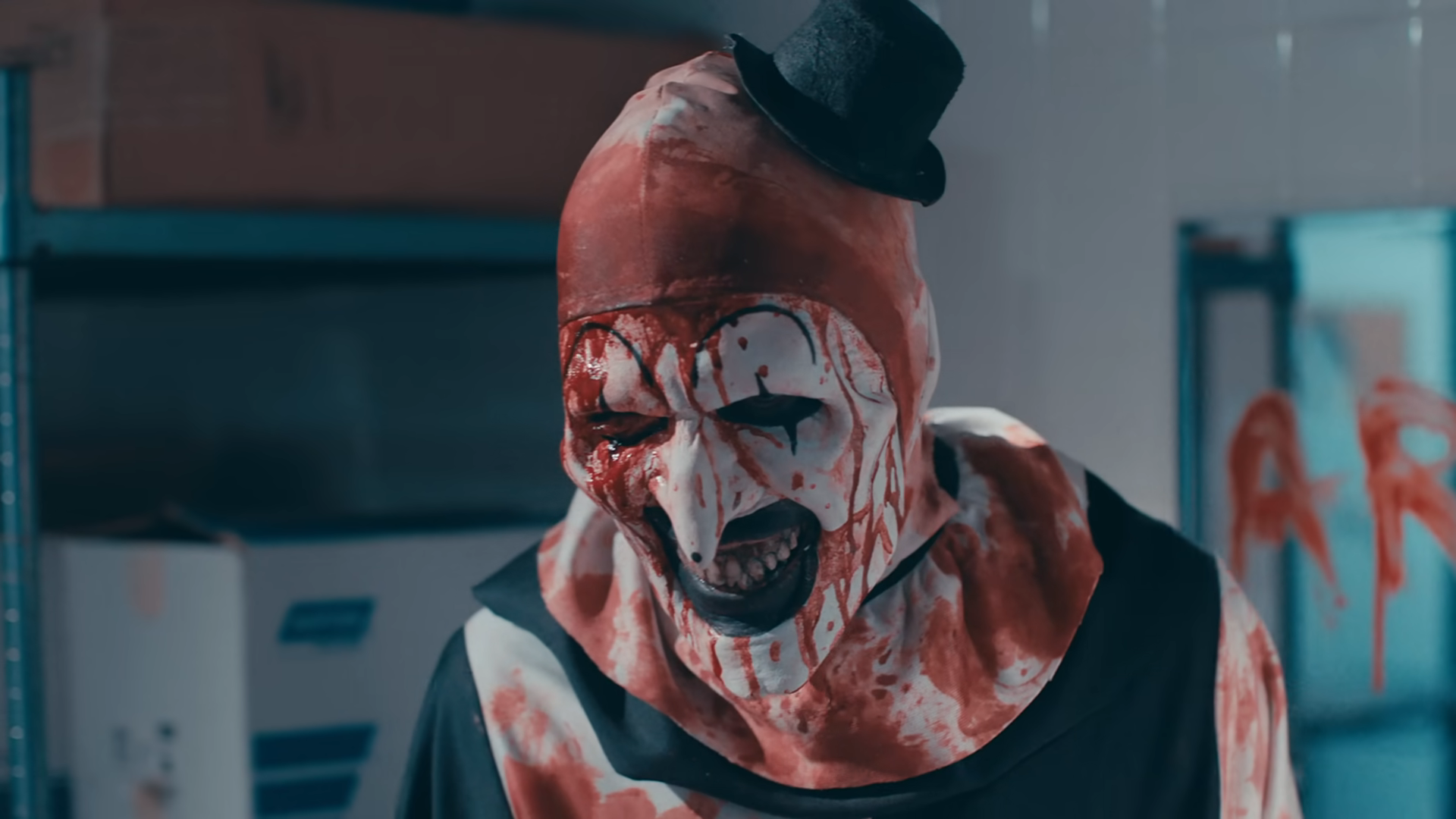 Art the Clown covered in blood and grinning