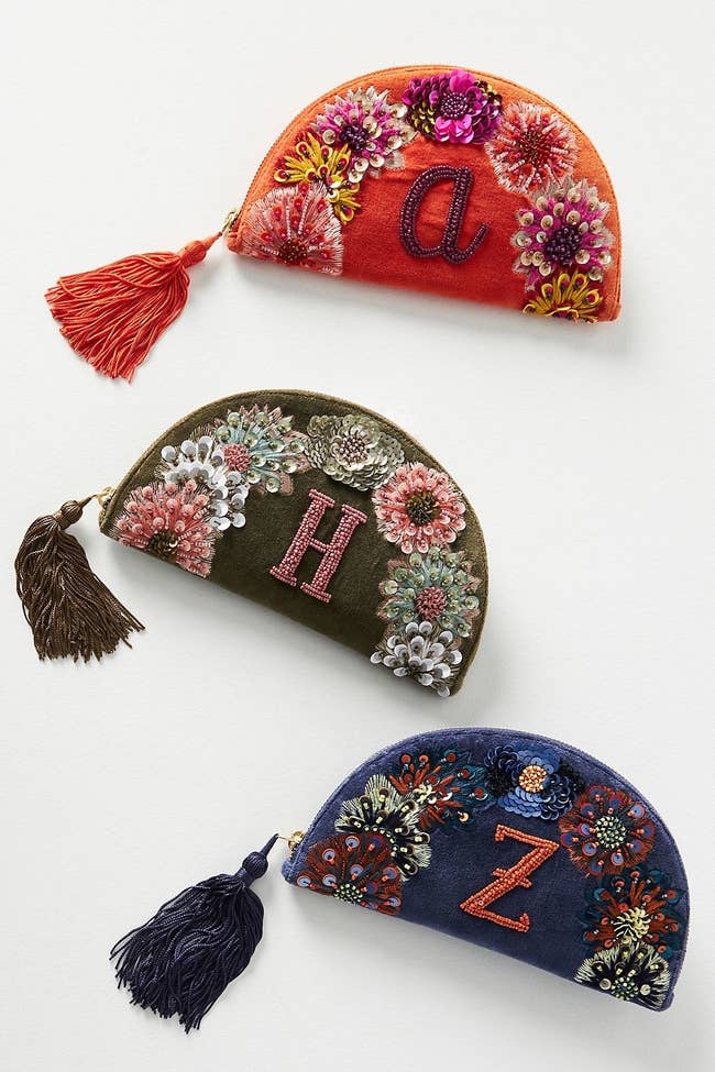 three different clutches monogrammed with an 