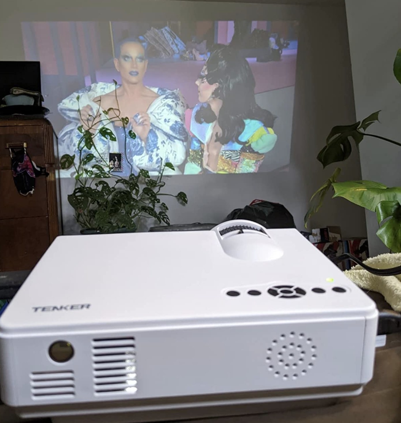 reviewer photo showing the projector in the foreground playing a show