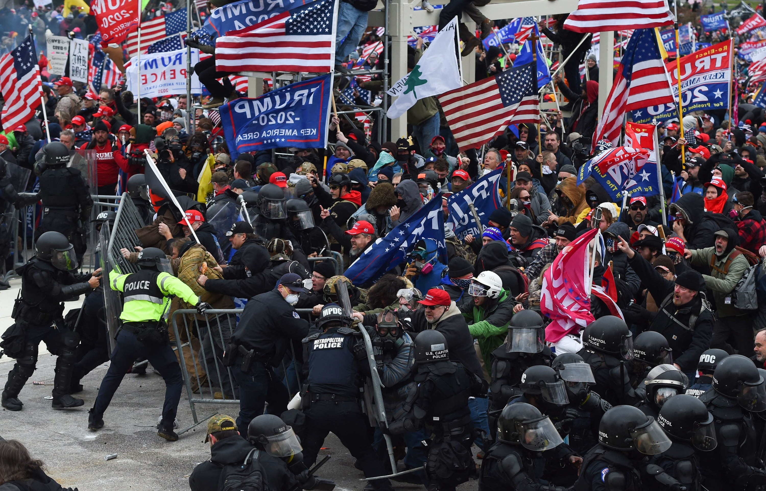 A crowd of Trump supporters clash with police and security forces as they push barricades to storm the US Capitol in Washington D.C on January 6, 2021. - Demonstrators breeched security and entered the Capitol