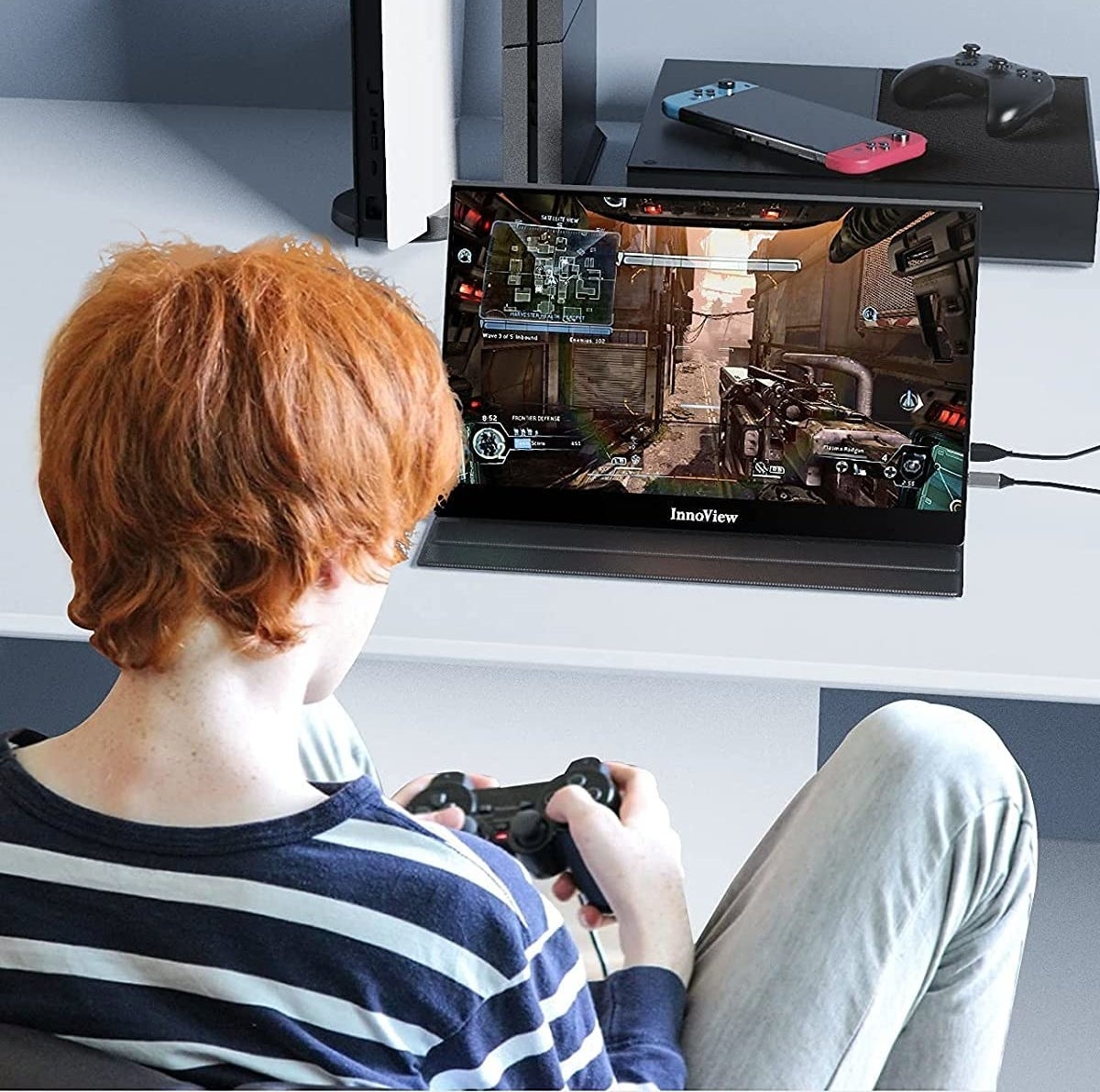 person playing a video game with their console connected to the screen