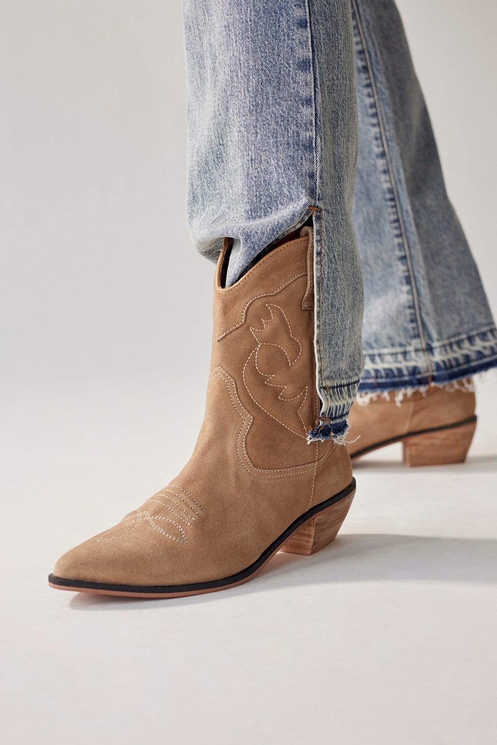 brown, light brown, and cream colored patterned mid-height cowboy boots with a slight wood heel