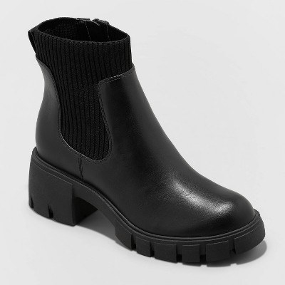 black boots with a ribbed sock portion and a chunky heel